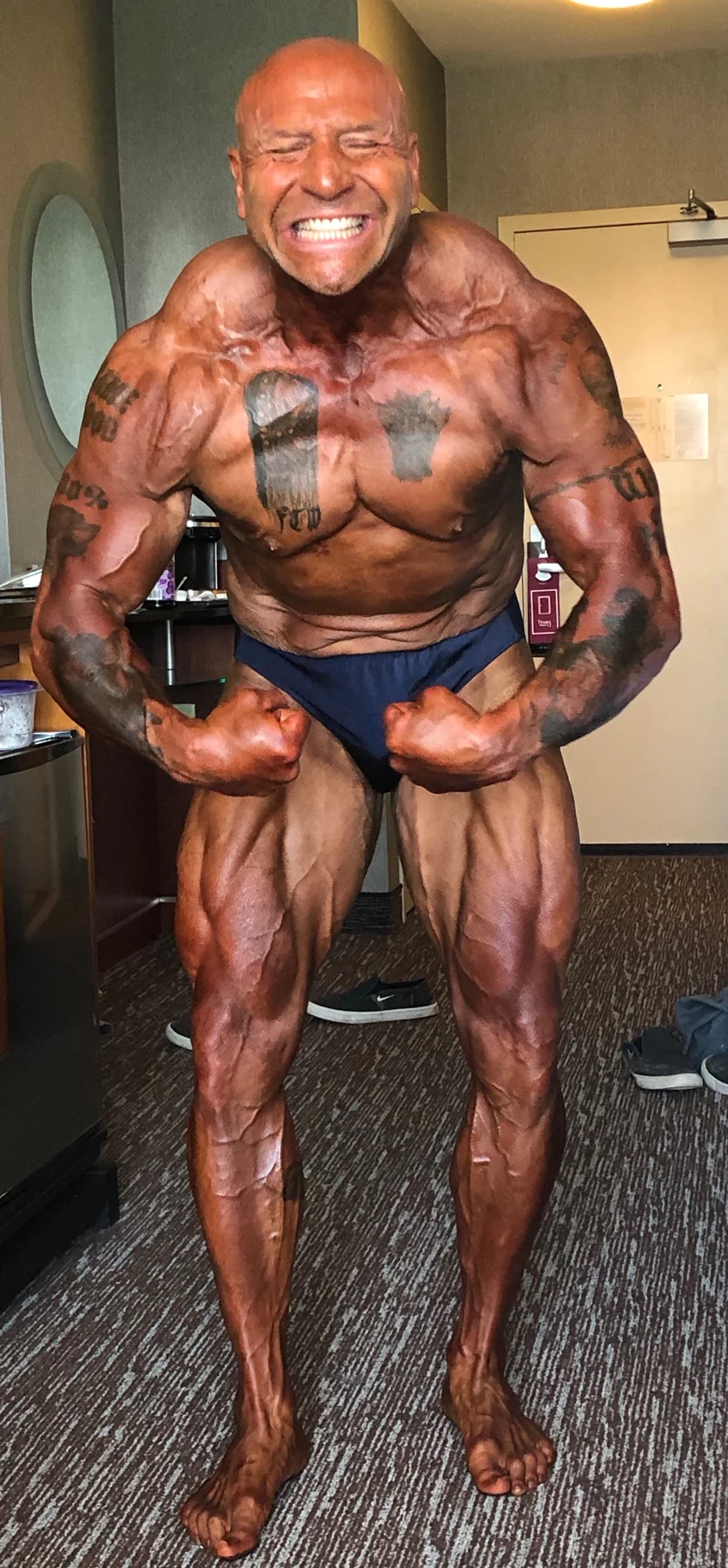 Jim Steel posing before his bodybuilding competition