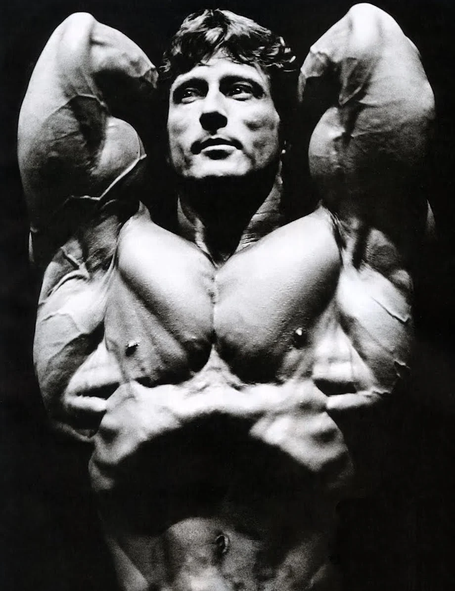 World champion bodybuilder Frank Zane performing a classic bodybuilding pose, showcasing his aesthetic physique and symmetry.