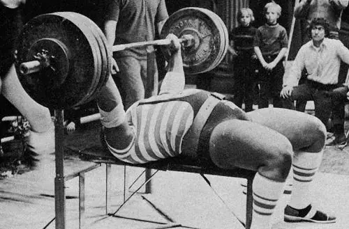Powerlifter performing a heavy raw bench press
