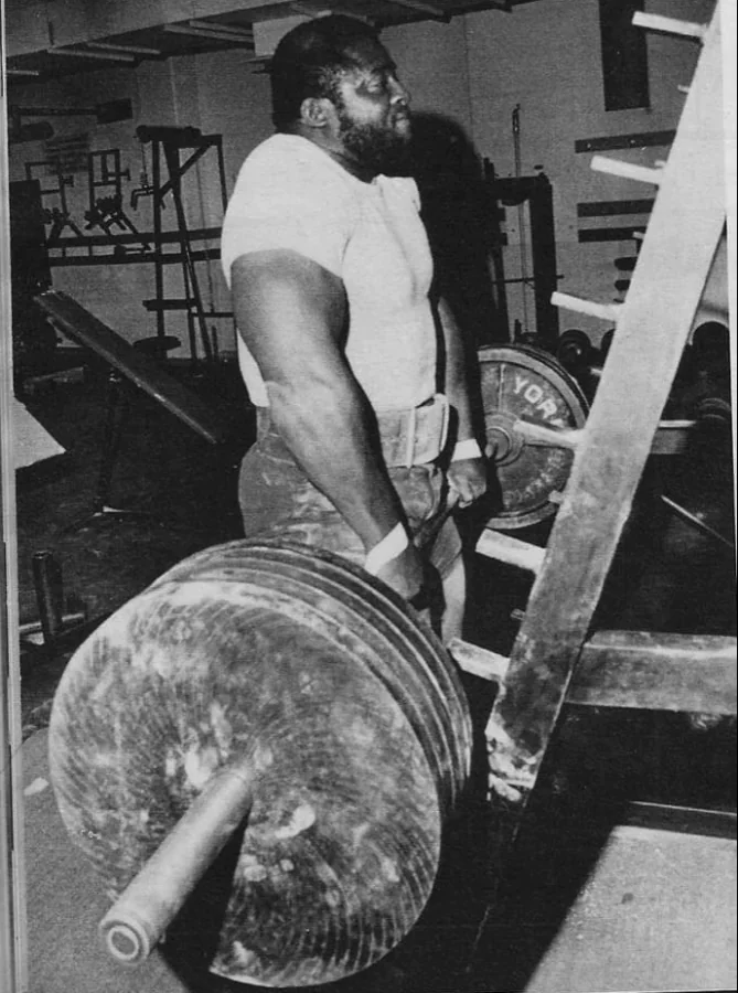 John Gamble performing heavy barbell shrugs