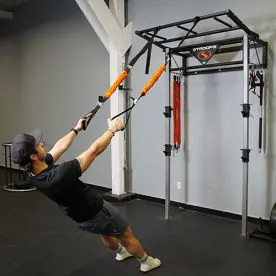 An athlete Using the Stroops Body Weight Gym with Slastix Bands in a Suspension Training Setup, Demonstrating Strength Exercises