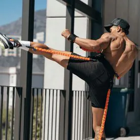 Athlete Wearing Stroops Slastix Python Striker Resistance Training Suit with Arm and Leg Bands Attached for Full-Body Speed and Agility Workout