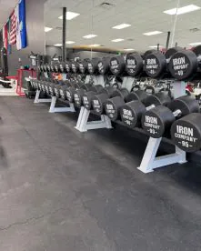 SurfaceCo Games System 18mm Interlocking Rubber Flooring Installed Beneath Commercial Gym Dumbbell Racks