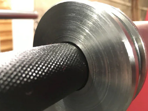 Close-up of machined Olympic bar collar