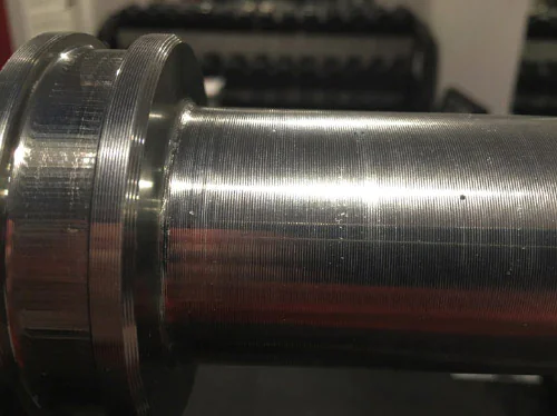 Close-up of Olympic bar machined sleeve