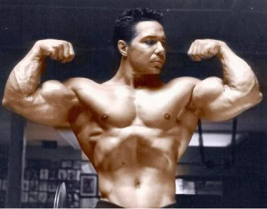 Athlete flexing biceps during a bodybuilding pose