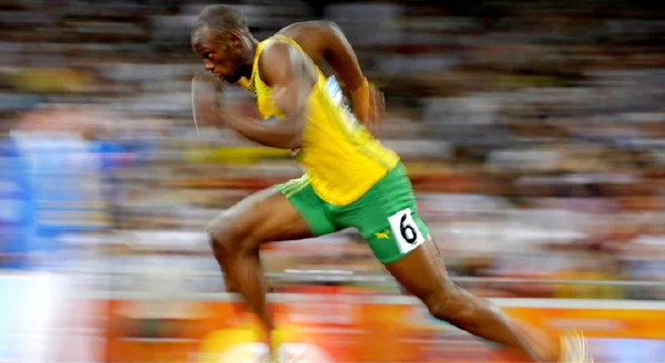 Elite sprinter running at full speed on a track
