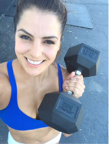 Athlete using rubber hex dumbbells in functional fitness training