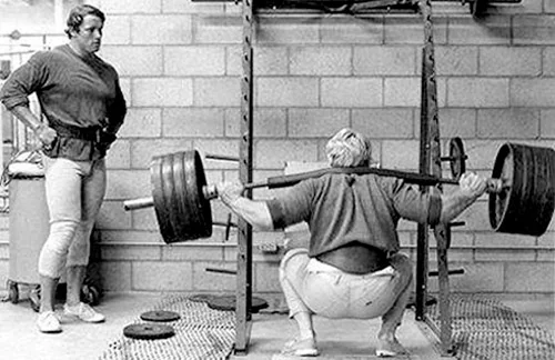 Athlete performing a full-depth barbell squat