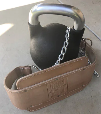 Leather dipping belt connected by chain to a kettlebell