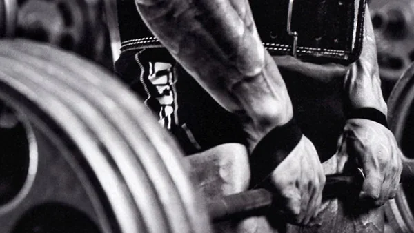 Athlete using weightlifting straps during a deadlift