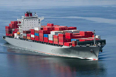 Fully loaded container ship transporting IRON COMPANY gym equipment and flooring to GSA customers and military bases around the world as part of global procurement logistics.