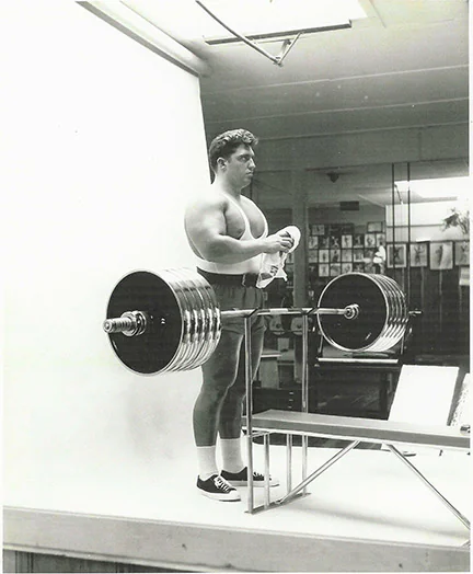 Pat Casey preparing to bench press heavy barbell