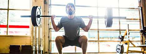 Athlete performing a barbell back squat