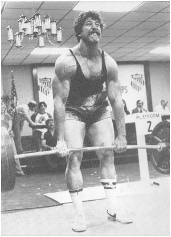 Powerlifter deadlifting a loaded barbell in competition