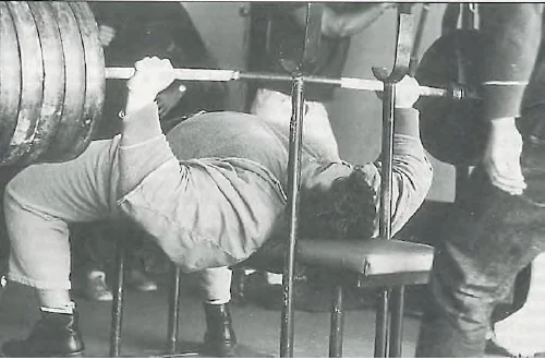 Athlete performing a barbell bench press