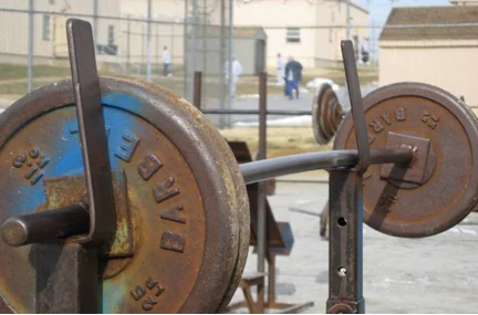 Barbell bench press setup in a prison yard