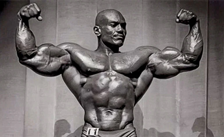 Bodybuilder flexing onstage during a physique competition