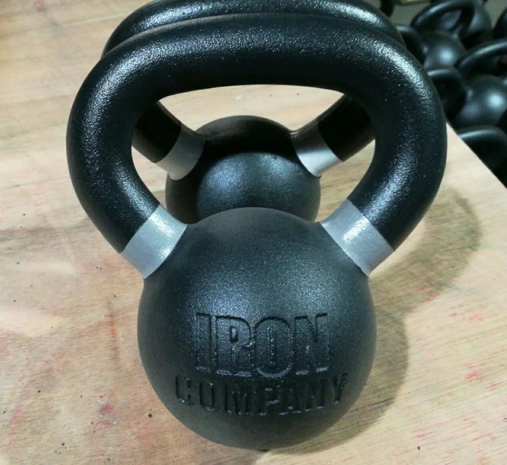 Close-up of an IRON COMPANY powder-coated cast iron kettlebell, showcasing its durable finish and ergonomic handle.
