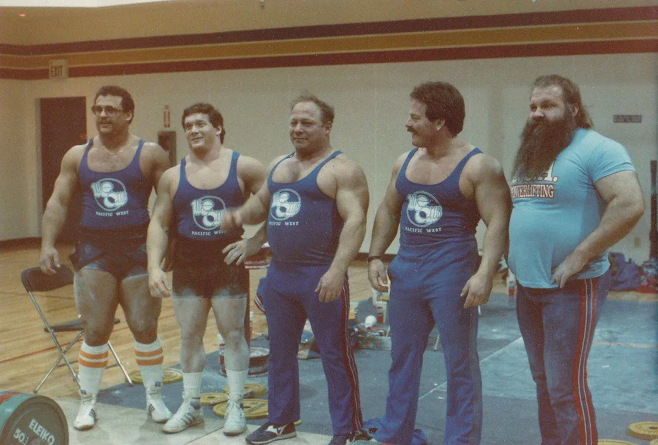 Five powerlifters standing together before competition