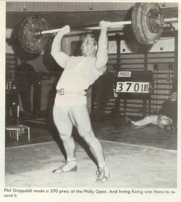 Phil Grippaldi performing a 370-pound overhead barbell press