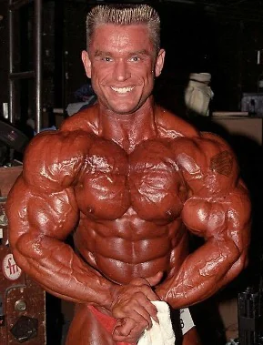 Competitive bodybuilder posing in extreme contest condition