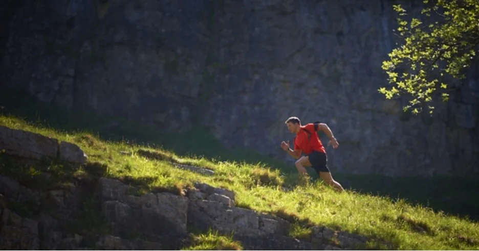 Man running uphill on a farm trail