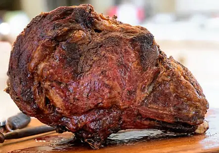 Cooked meat on a cutting board for strength-athlete meal prep
