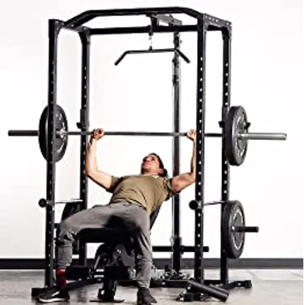 Athlete bench pressing inside a power rack with safeties set too low
