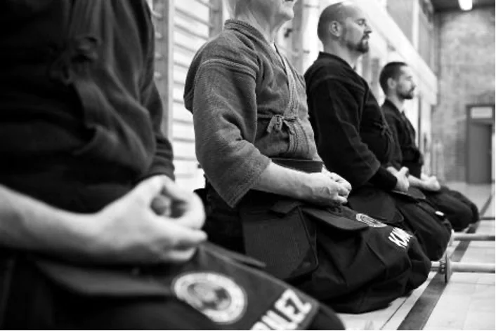 Men meditating before martial arts practice