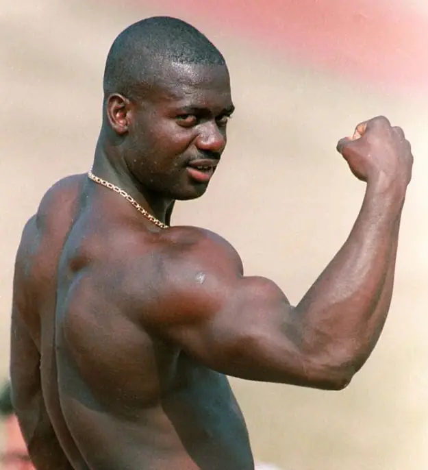 Sprinter Ben Johnson hitting a bicep shot demonstrating his advanced muscularity