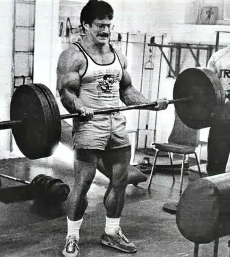 Mike Mentzer performing a heavy barbell curl