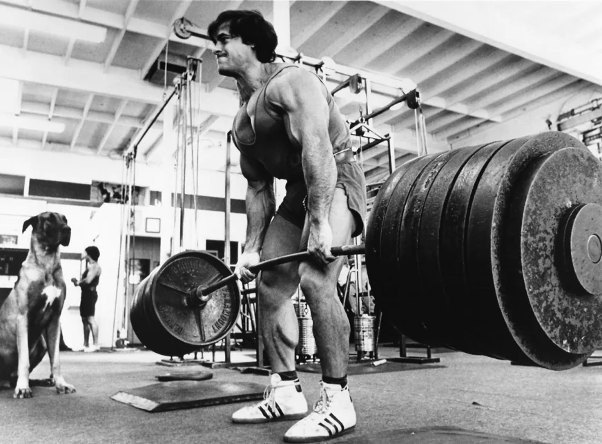 Bodybuilder Franco Columbu performing barbell deadlifts