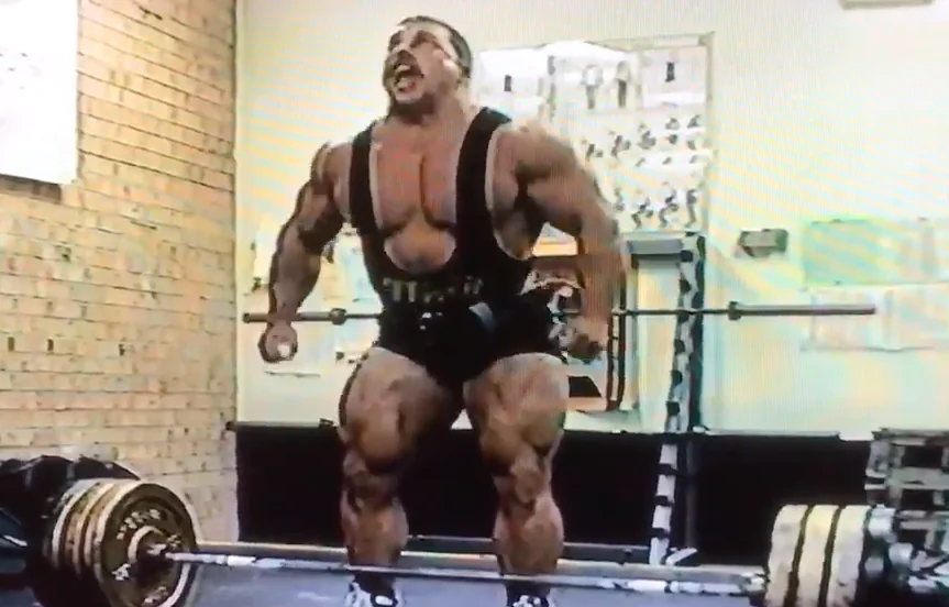 Kirk Karwoski preparing to deadlift a loaded barbell