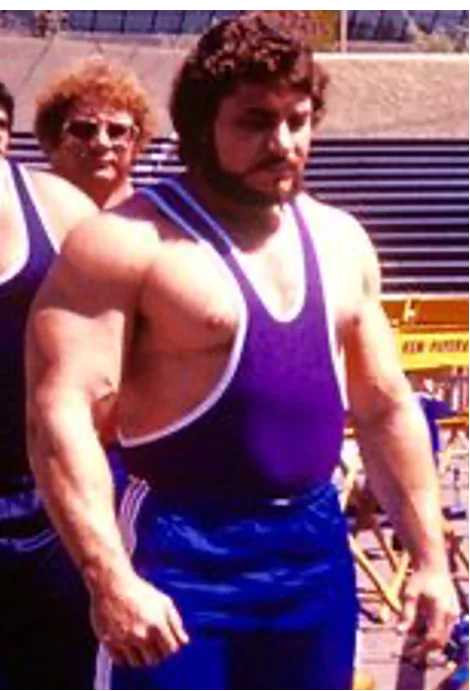Jon Cole posing as a powerlifter and all-around strength athlete