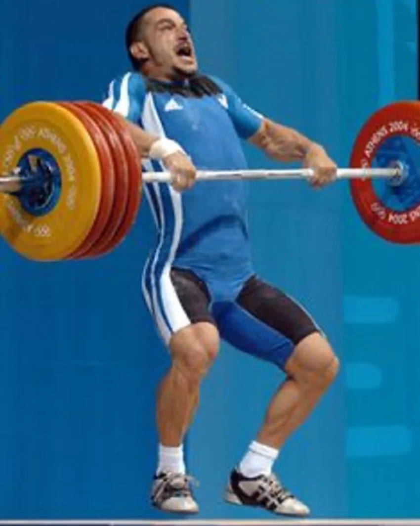 Olympic weightlifter performing an explosive power clean pull